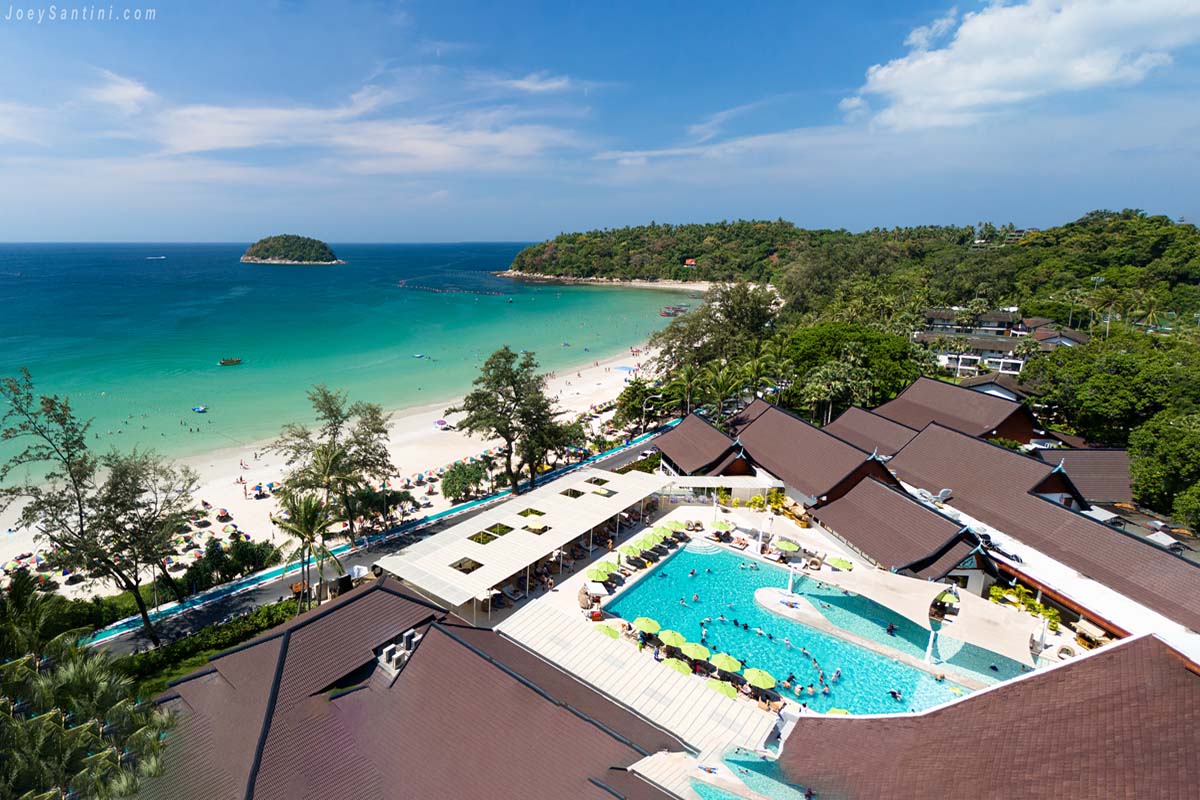 Shot of a brown roof of and at the blue swimming pool of the hotel