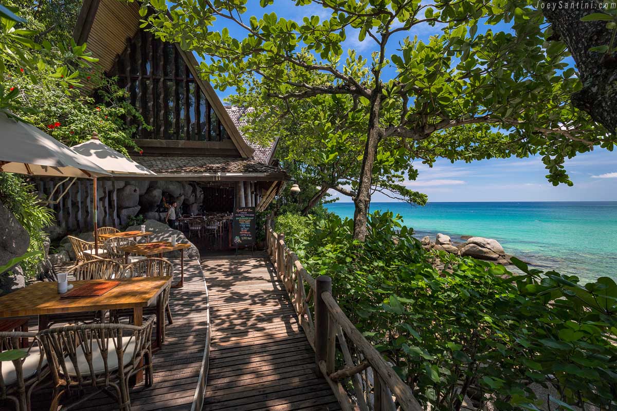 Wooden restaurant with green trees and blue ocean