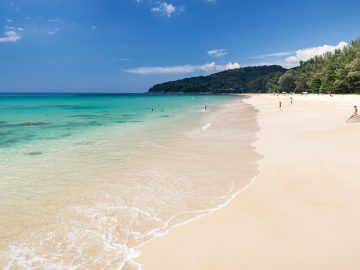 Blue clear waters and white sand of Naithon Beach Phuket