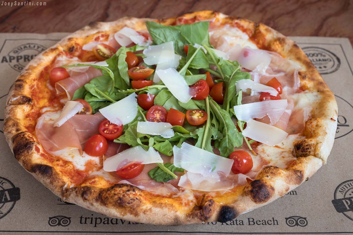 Pizza with rocket, parmesan and small tomatoes