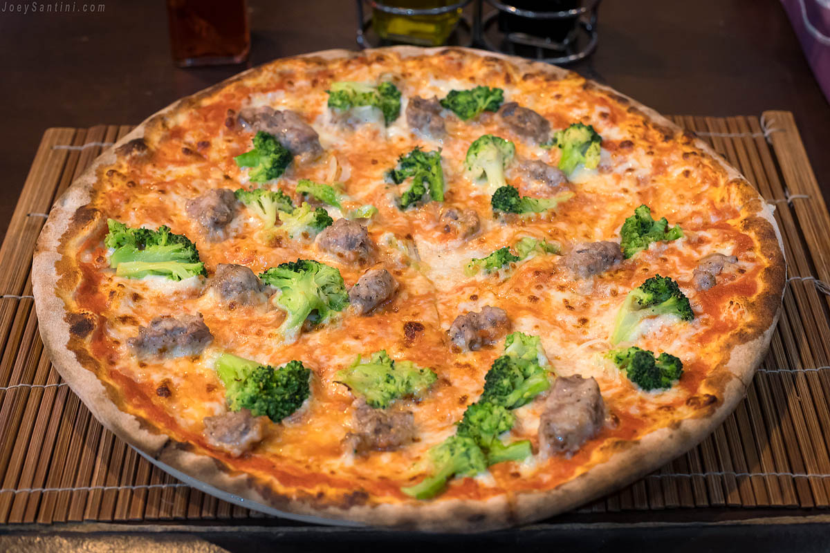 Pizza with broccoli, cheese and sausage