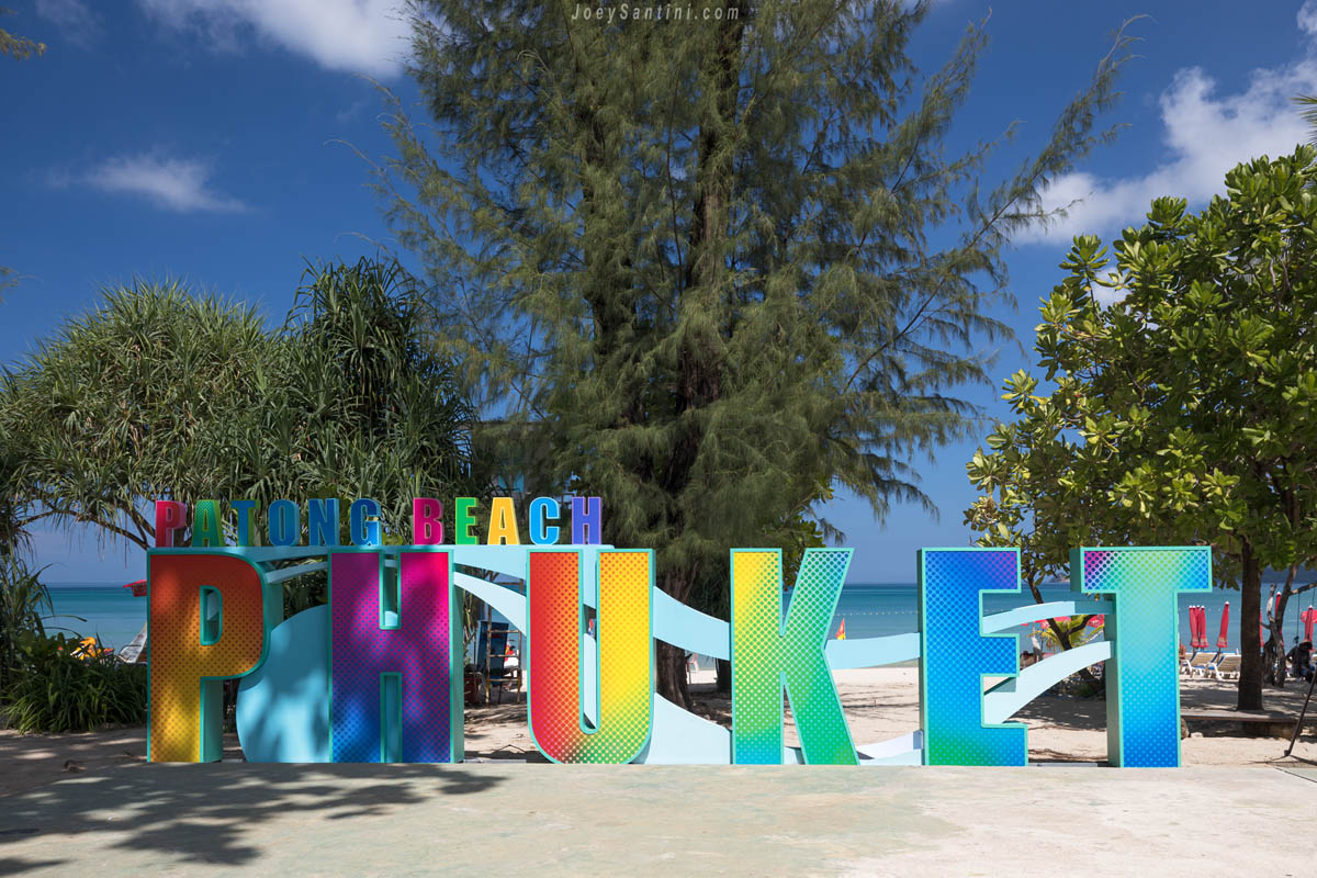Colorful letters with trees in the background