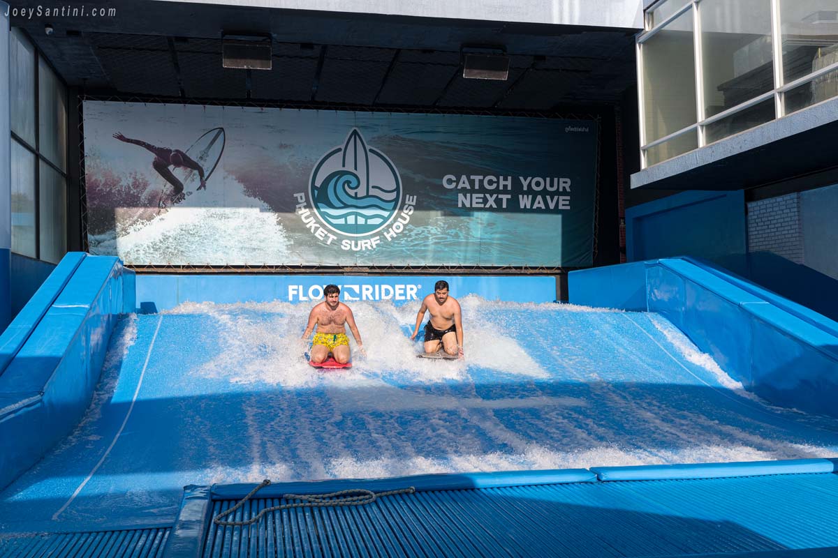 two men flowboarding on artificial wave at surf house patong phuket