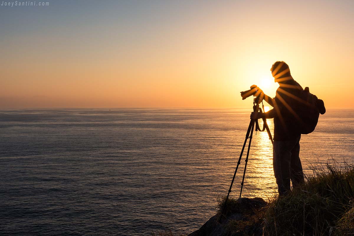 Shot of a photographer with a golden sunset in the background