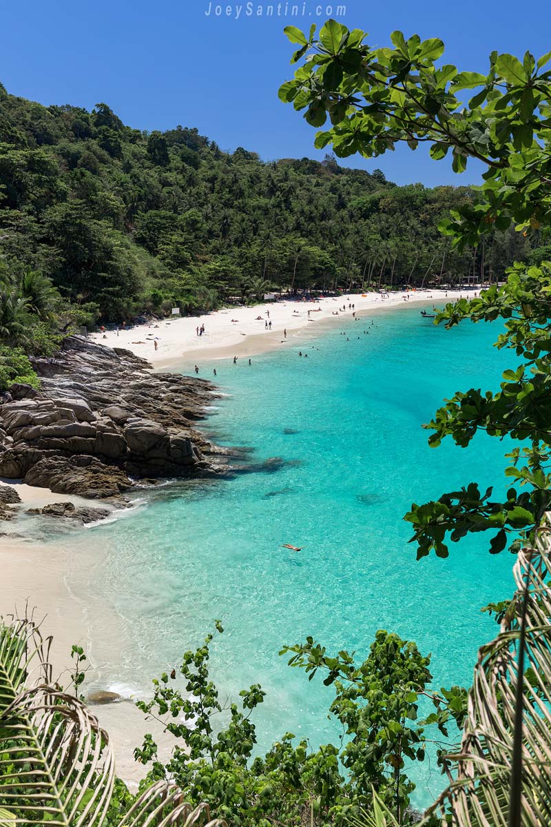 Panoramic view of Freedom Beach with rocky cliffs and crystal clear sea from above.
