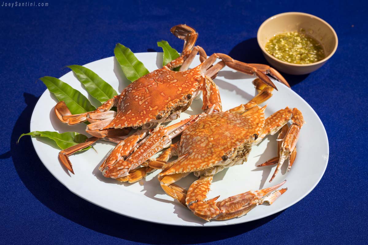 Red crabs on a plastic dish with blue tablecloths