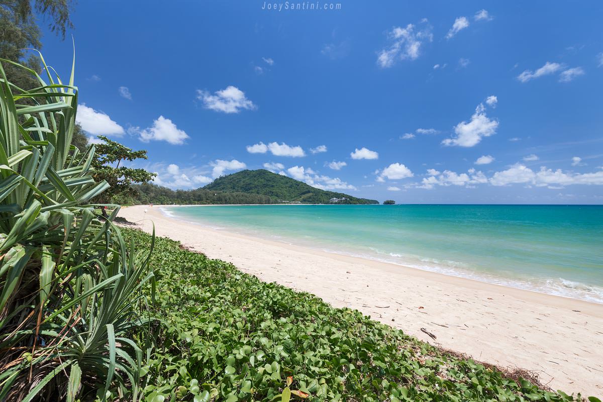 Shot of the white sand and blue seas of Nai Yang beach with blue sky in the background