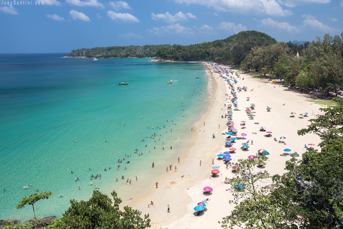 Shot of Surin beach from above with turquoise water and umbrellas on the sand