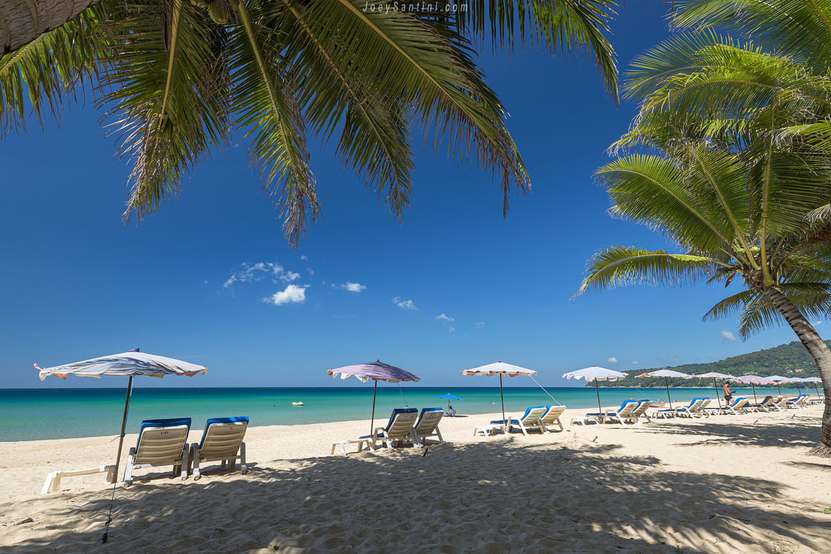 Shot of Karon beach with loungers and umbrellas with blue sky in the background
