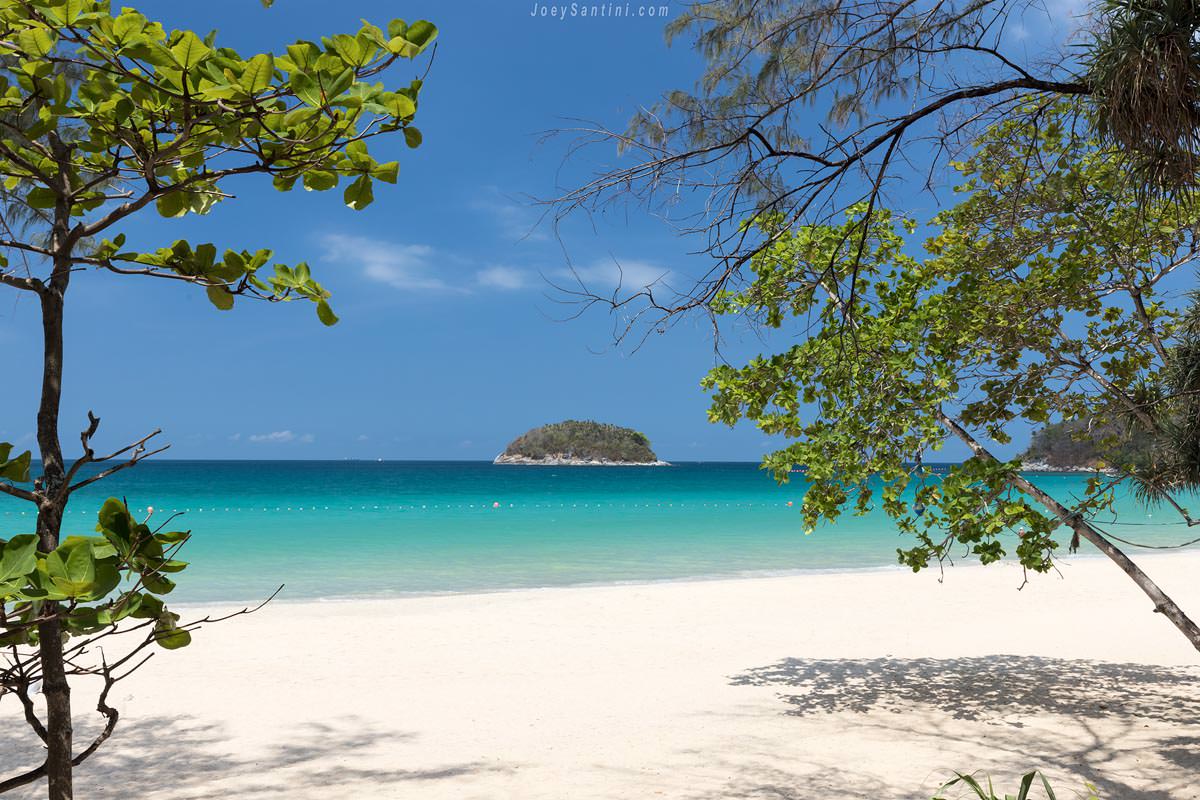 Shot of Kata beach with white sand and clear ocean with blue sky in the background
