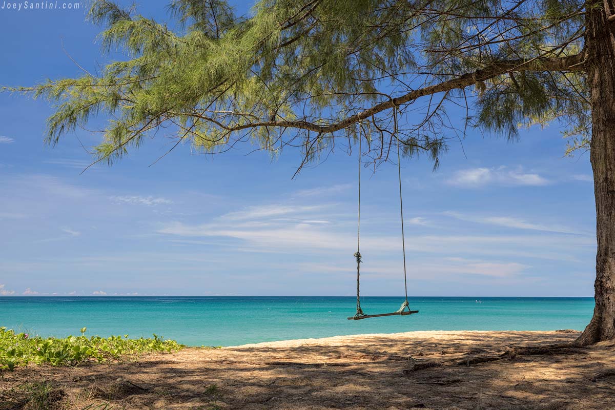 Shot of a swing with blue seas of Mai Khao beach