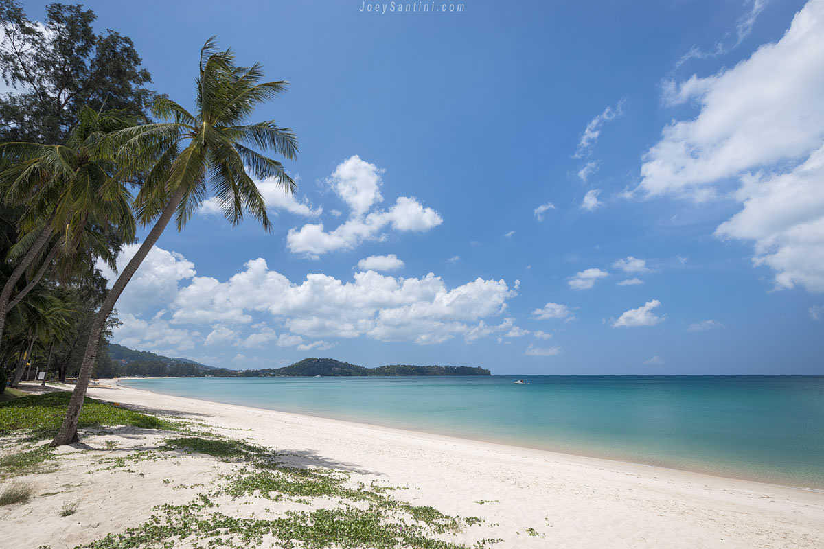 Shot of the white sand of Bangtao beach with blue ocean and blue sky sky