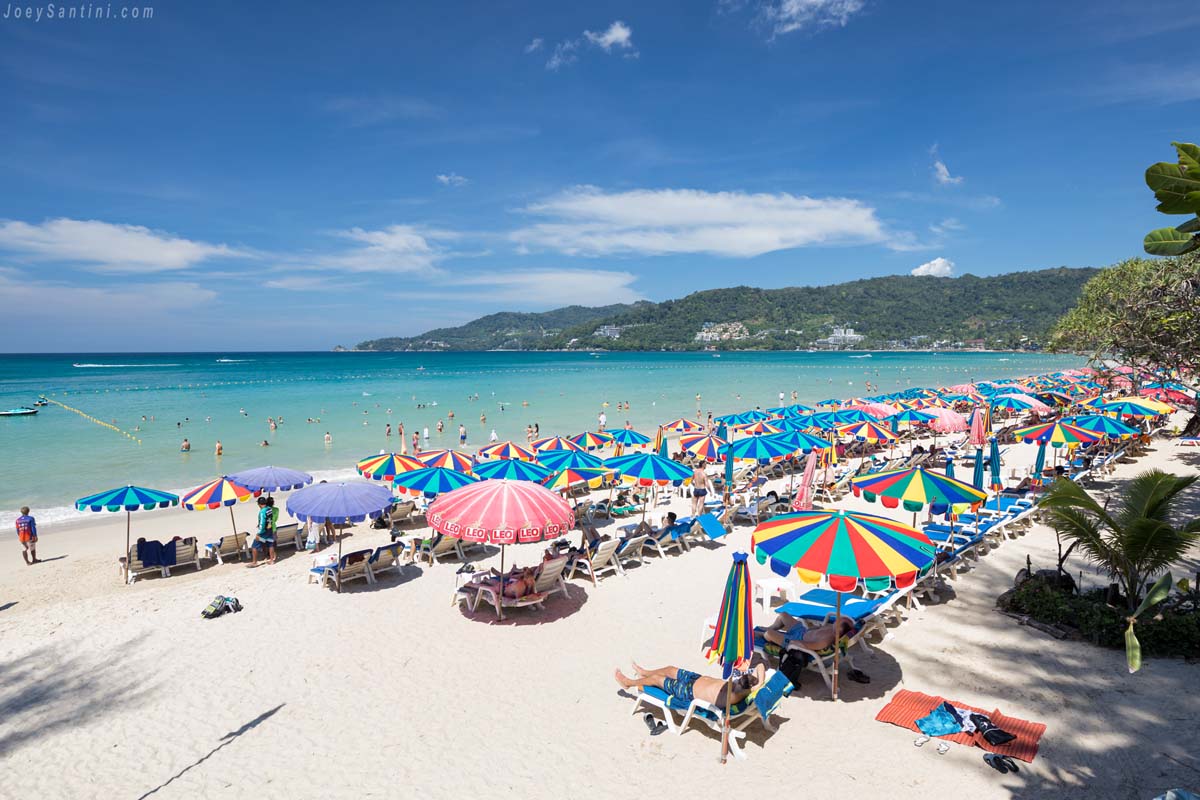 Shot of the umbrellas on Patong beach with blue ocean and blue sky in the background