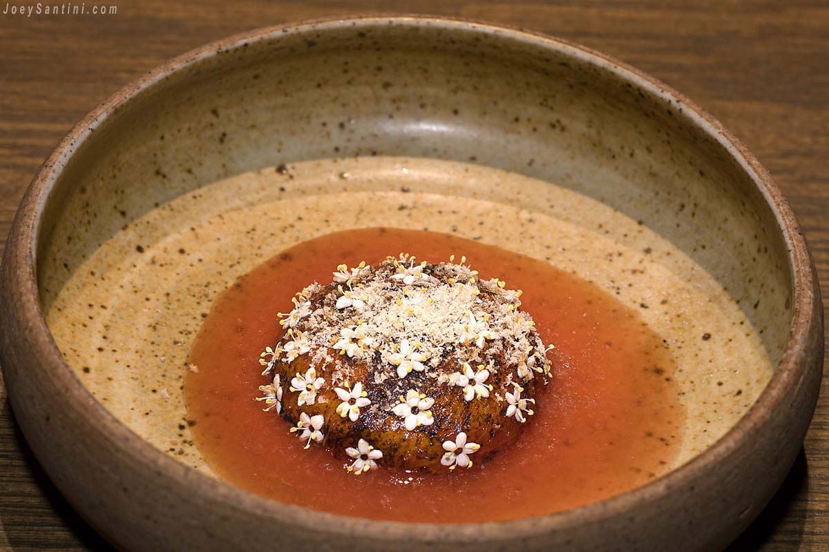 Shot of the Dhala Flower food with white flowers and red watermelon sauce