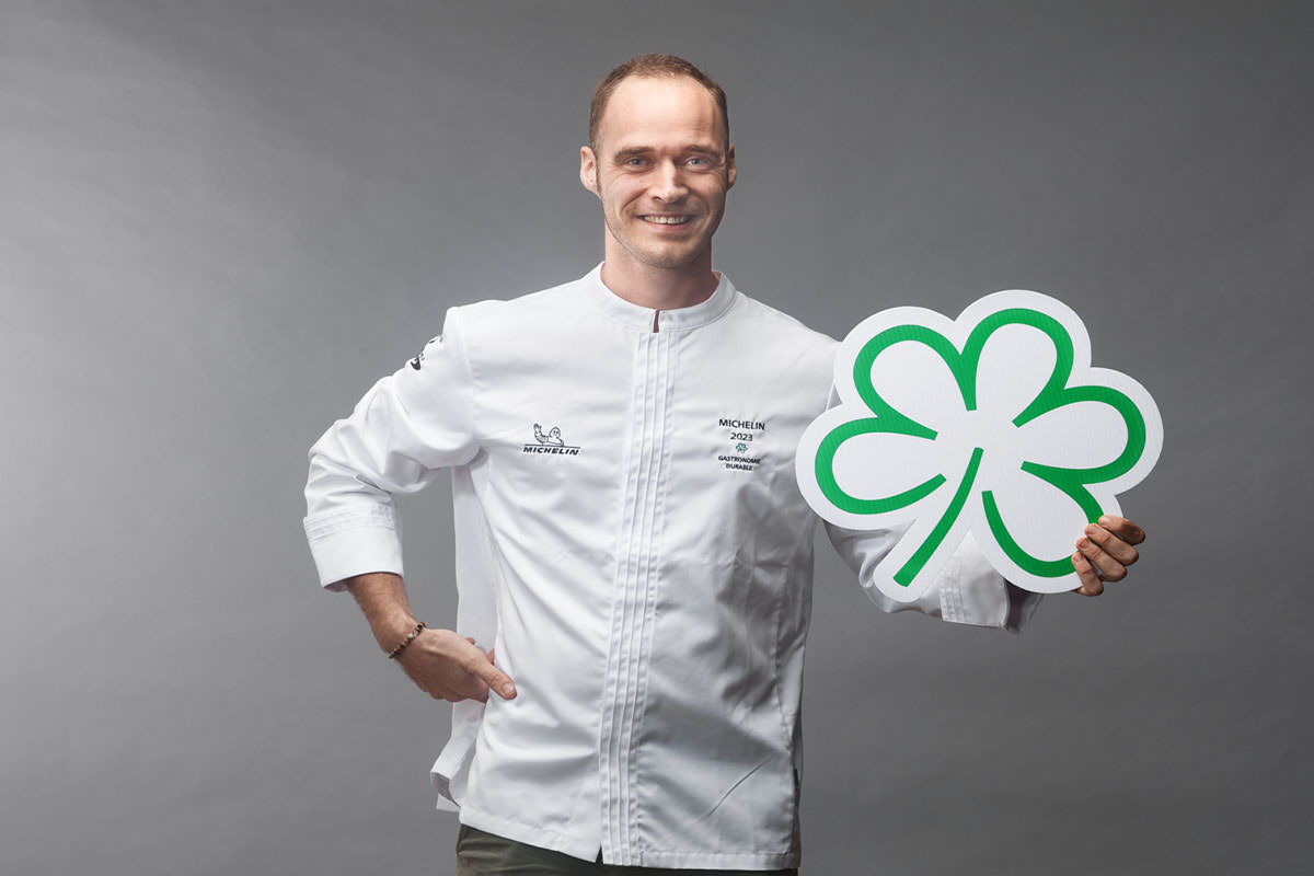 Shot of the Chef holding the Michelin Green Star award