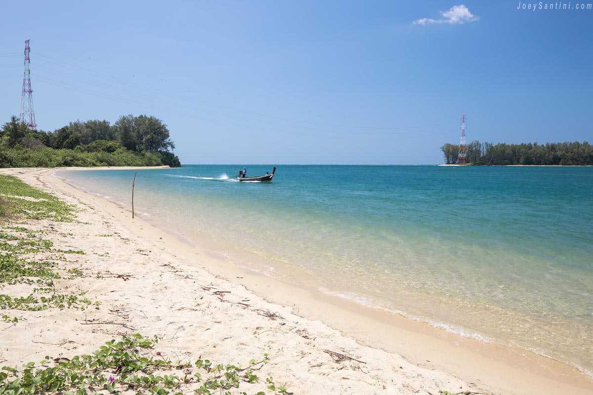 Shot of the sand and blue waters of Pak Phra Beach