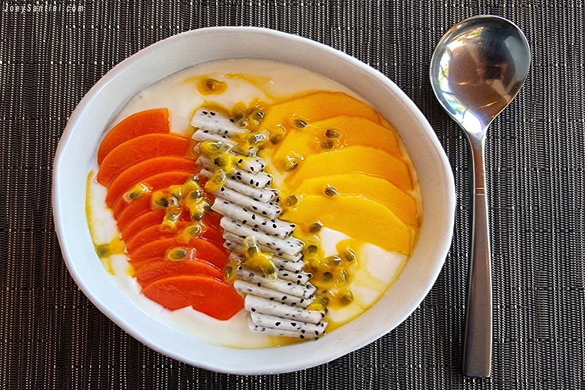 Shot of orange papaya, dragon fruit and yellow mango in a white bowl