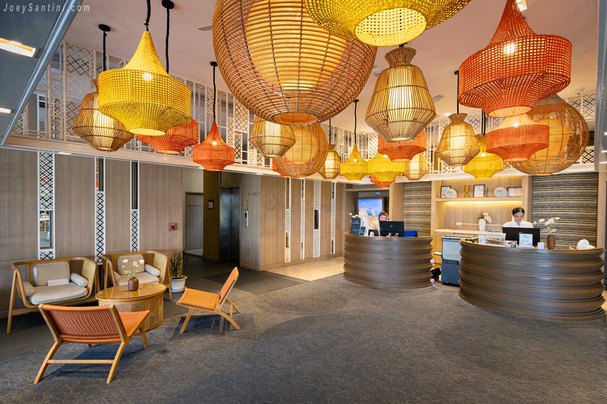 Lobby and reception with woven basket lamps at Andaman Beach Hotel Phuket