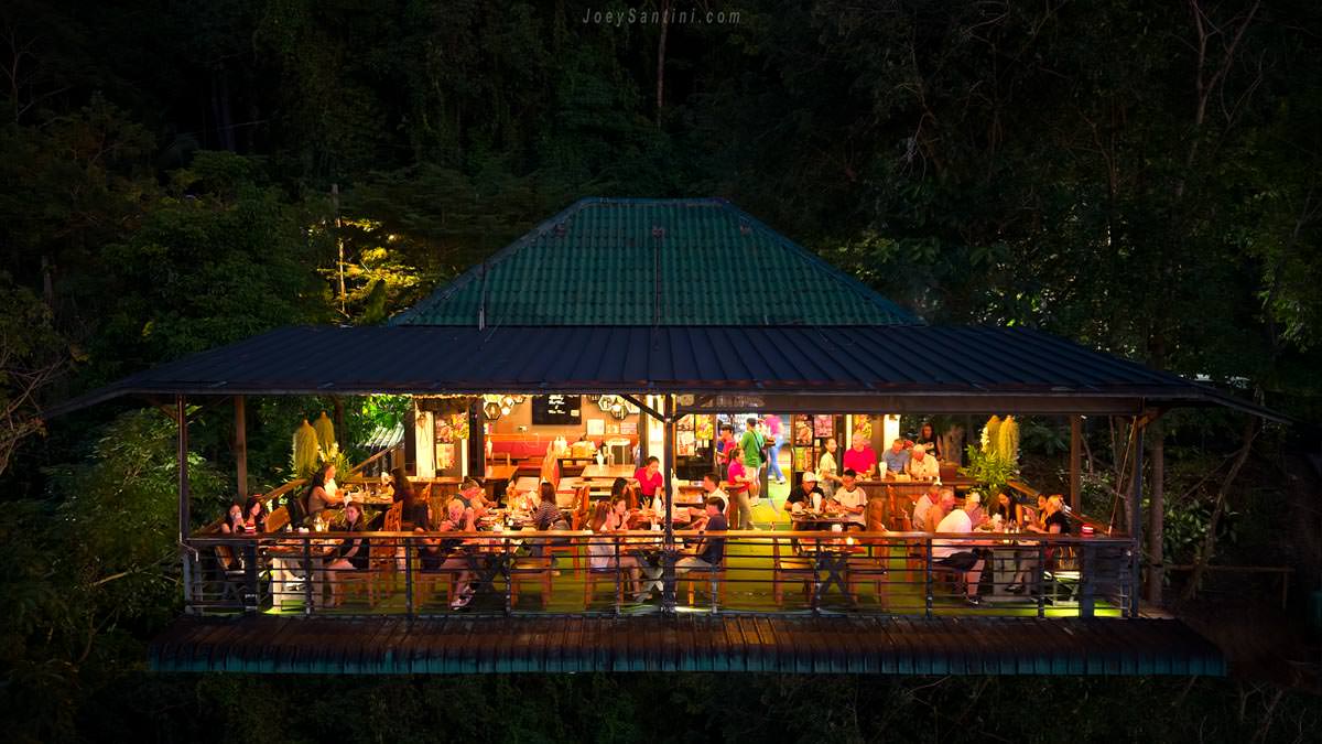 Patong Sunset View Restaurant in Phuket illuminated at night surrounded by lush jungle trees