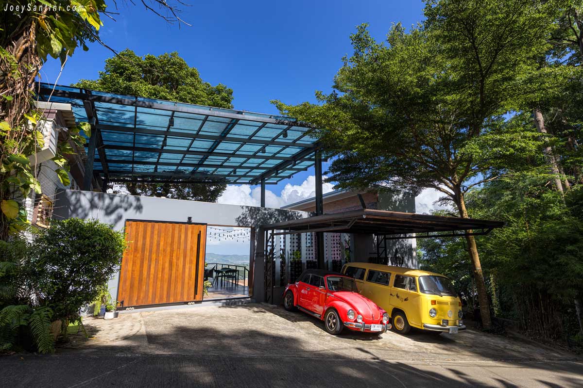 View Cafe at Phuket entrance with red vintage beetle and yellow camper van parked outside