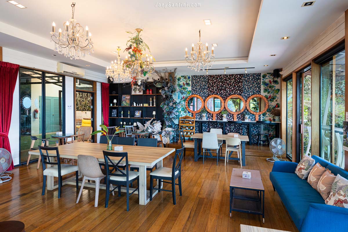 View Cafe at Phuket stylish indoor seating area with chandeliers floral wallpaper and sofas