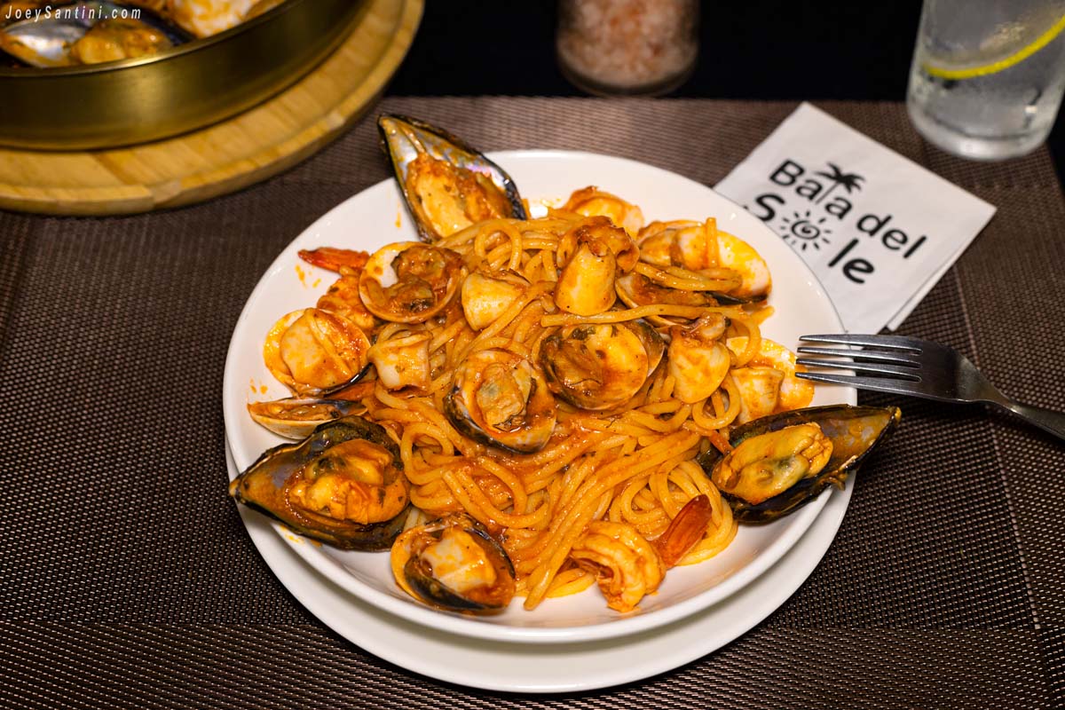 A plate of rich seafood spaghetti with mussels, clams, and shrimp served at Baia del Sole restaurant in Patong.