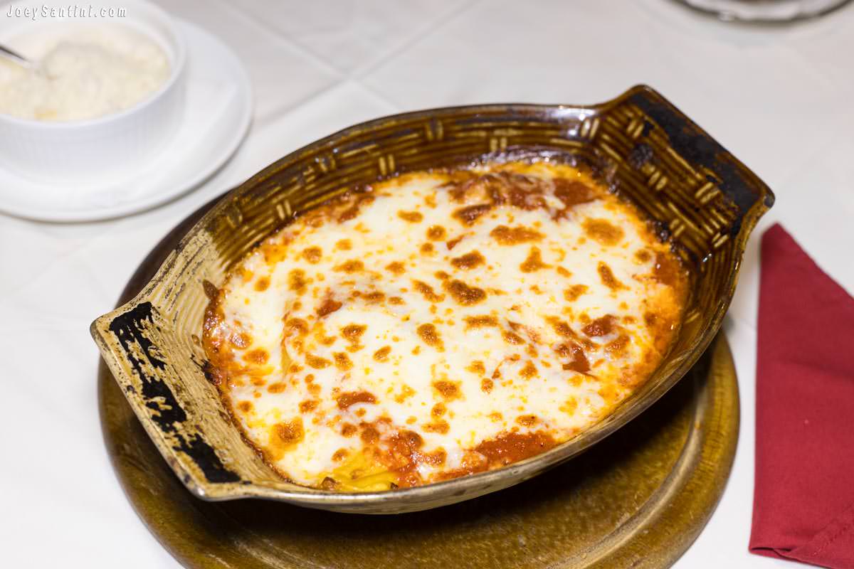 Traditional baked Italian lasagna with melted cheese at Roma Ristorante and Pizzeria Da Mauro