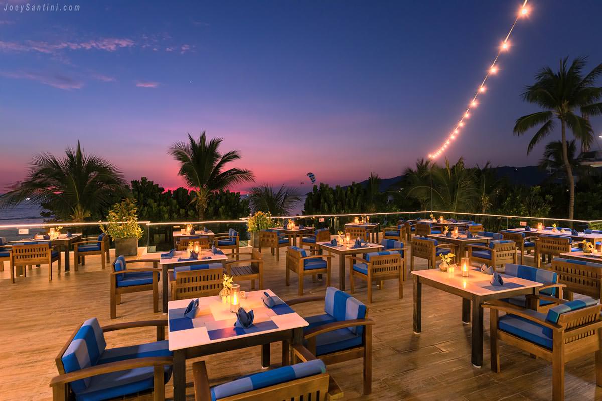 The Surface at La Flora Resort rooftop dining deck during a vibrant purple twilight over Patong Beach.