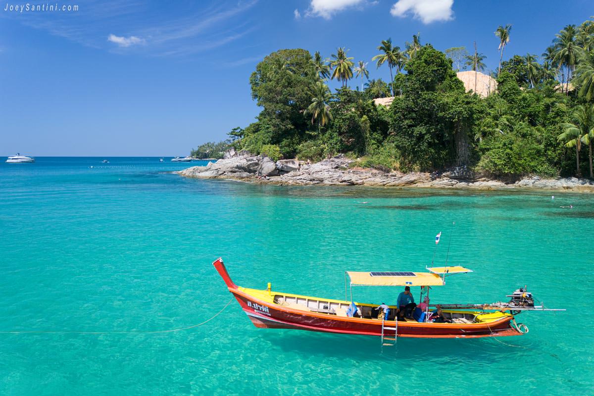 Brown local boat floating above the crystal clear waters