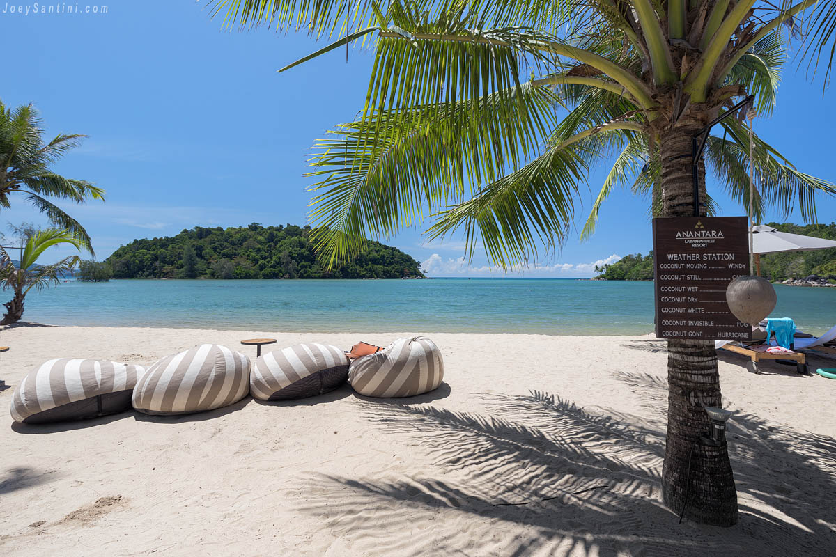 bean bag chairs under palm tree with anantara weather station sign on layan beach phuket