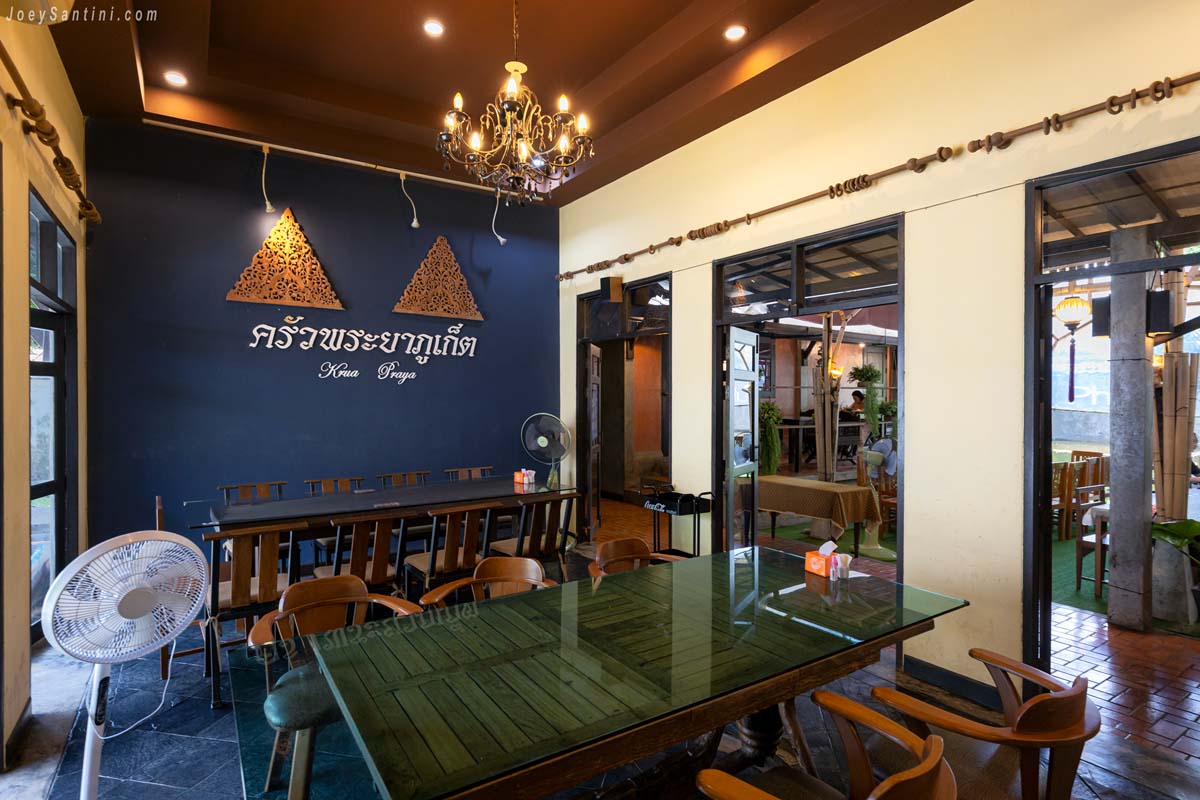 rua Praya Phuket air-conditioned indoor dining room with blue wall and wooden tables