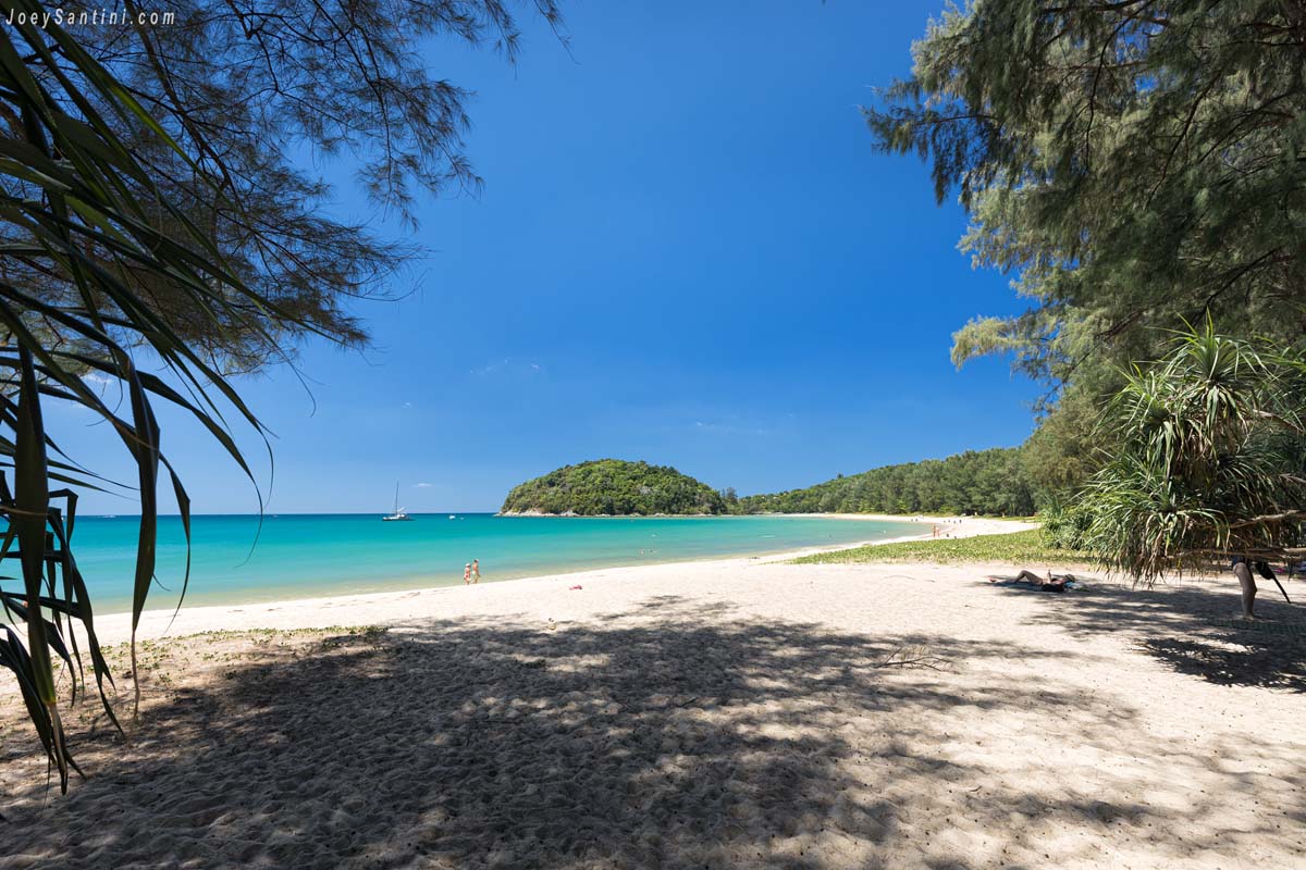 scenic view of layan beach bay and koh kala island framed by trees