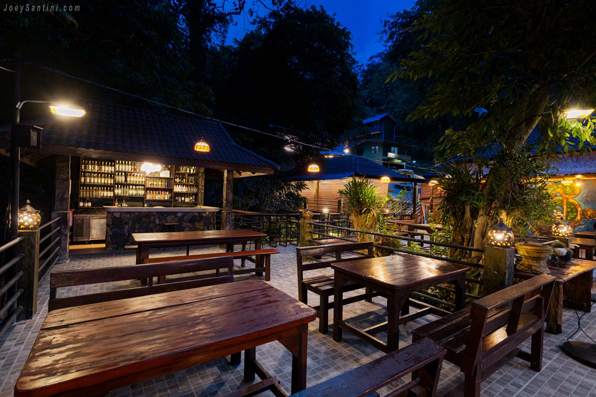 No 6 Restaurant Up The Hill Patong wooden dining tables and bar area at night