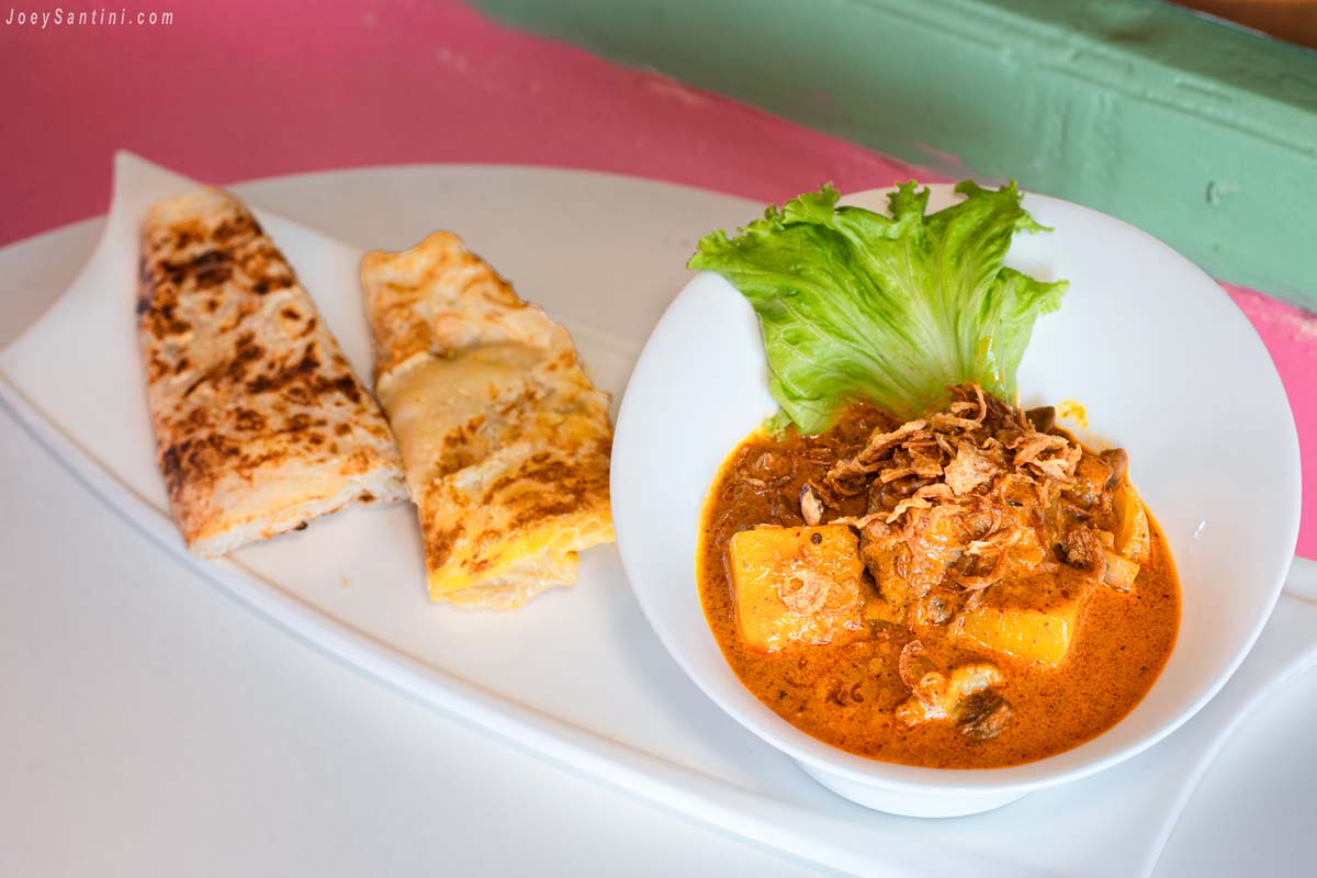 rich massaman curry served with golden crispy roti bread at sweet come phuket