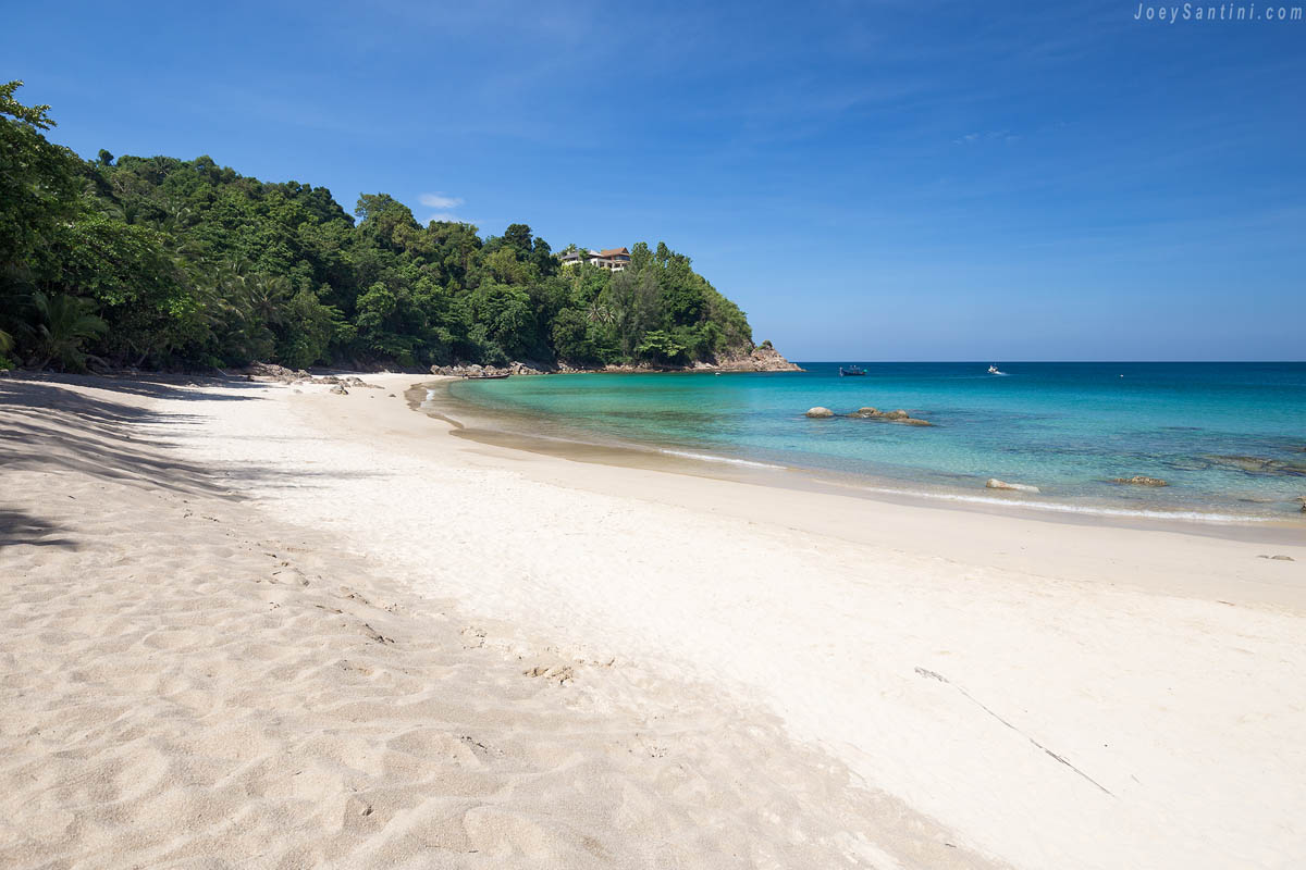 The white sand and calm turquoise sea of Banana Beach under a clear blue sky